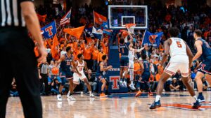 Texas Tech and Illinois college basketball players in action during a 2025 game at State Farm Center with vibrant crowd in background.