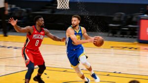 NBA action shot showing Golden State Warriors and New Orleans Pelicans players competing intensely during their November 2025 matchup.